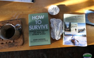 book How To Survive by John Hudson sitting on the table in the Guide Shack