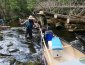 lifting canoe over logs