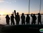 Canoe trippers on the beach watching the sunset