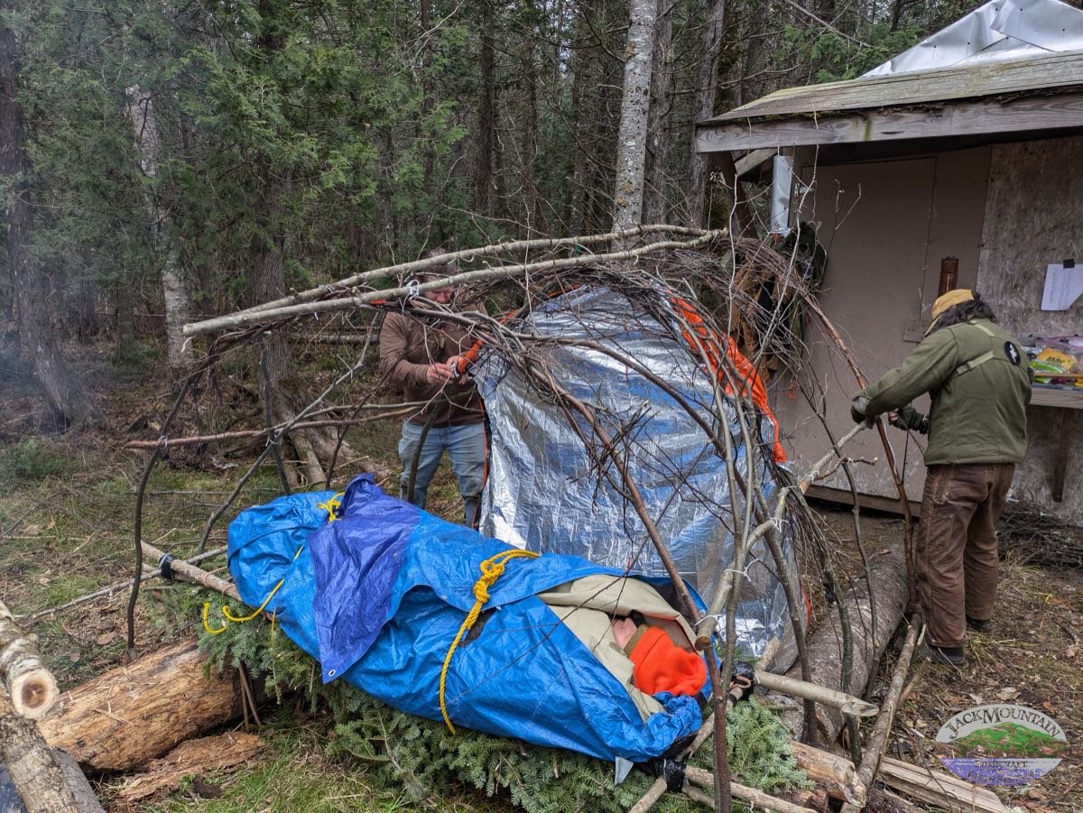 Survival shelter being built on a medical course