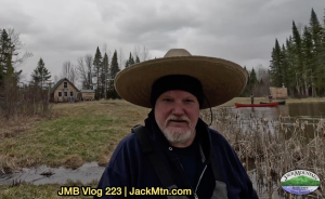 Tim walking near Grand Lac Samsquanch with canoes in the background