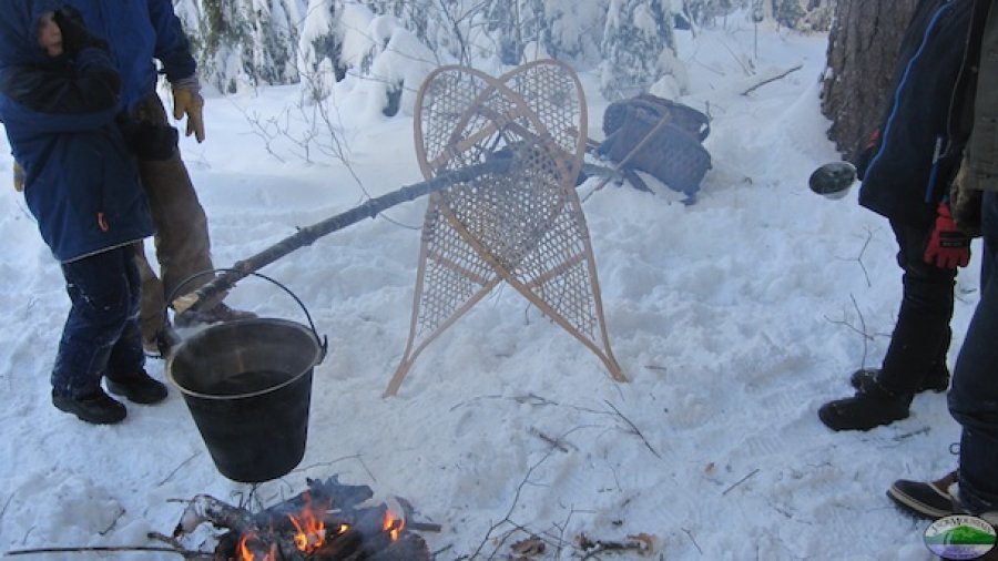 hanging a pot with snowshoes and a pole