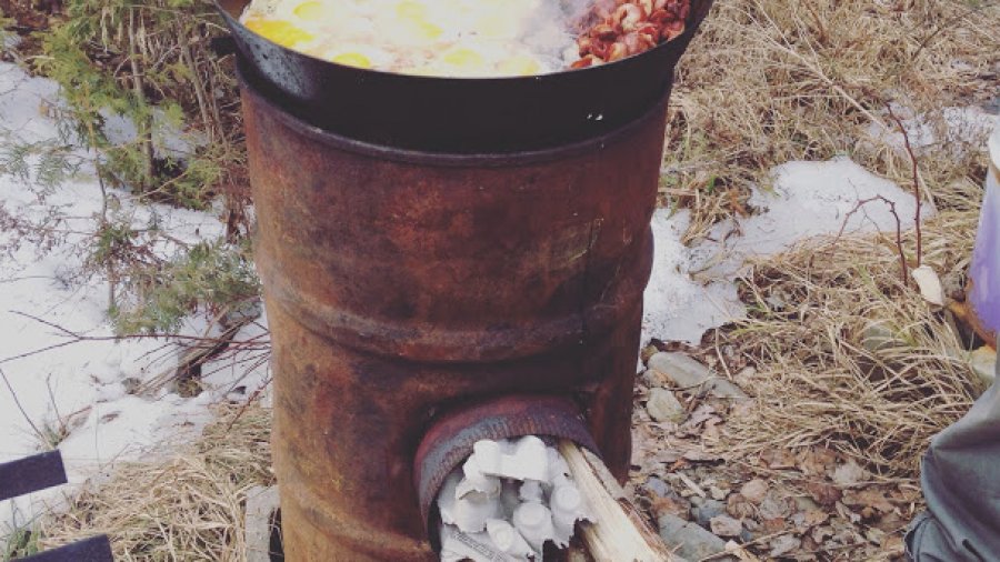 Big pan of breakfast on a big rocket stove