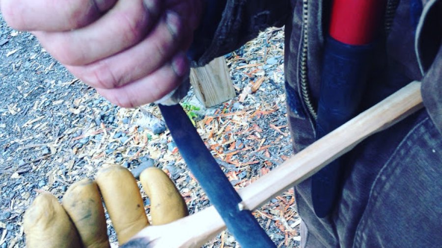 Carving a coal-burned spoon with a newly made crooked knife