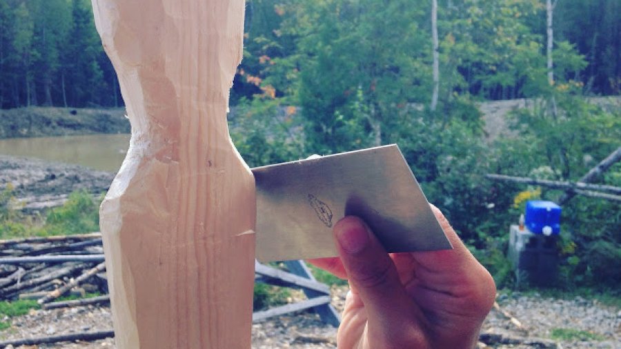 Using a cabinet scraper to smooth a paddle grip