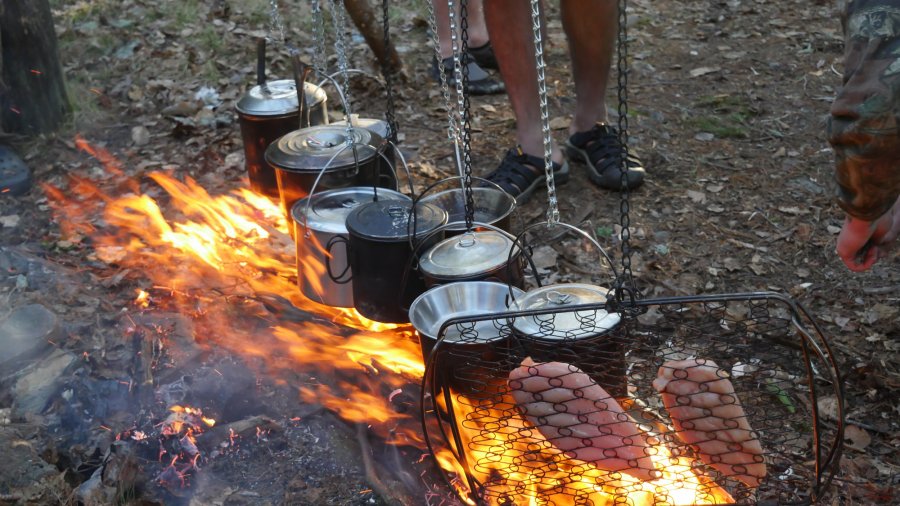 A bush cooking fire with lots of pots hanging