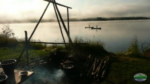 misty morning on a lake poling canoes