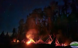 image of night fires in front of shelters for no sleeping bag exercise