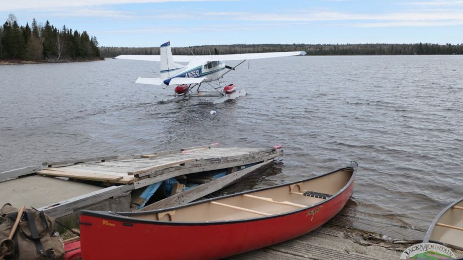 Float plane and one of our red Esquif canoes on a nearby lake