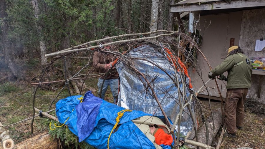 Survival shelter being built on a medical course