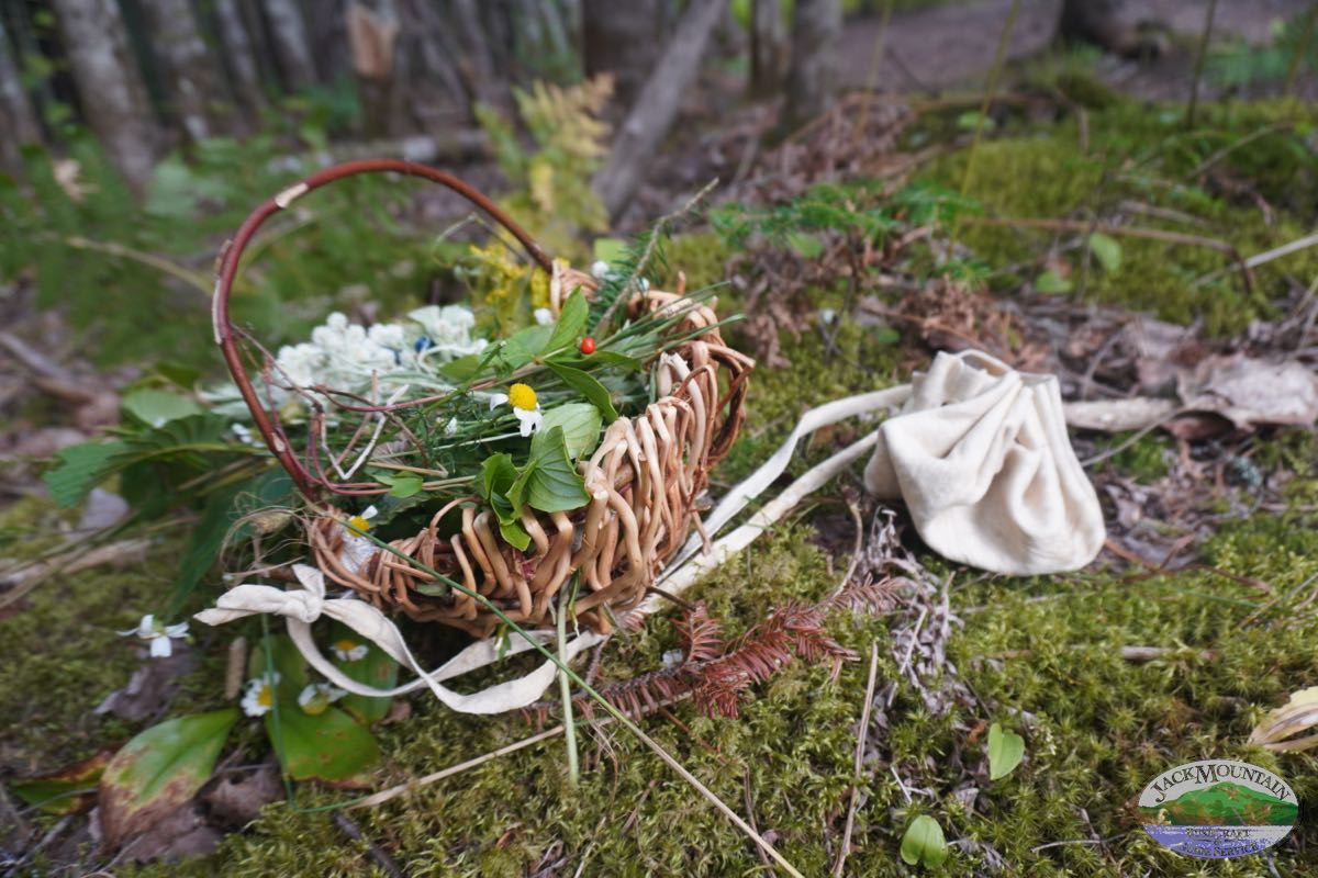 Handmade basket and braintan buckskin pouch.