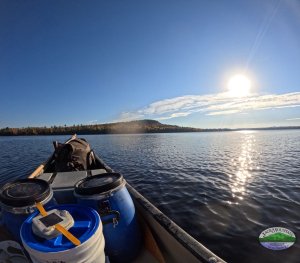 Sun rising over remote lake in northern Maine, as seen from canoe
