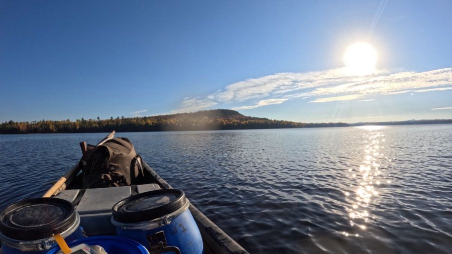 Sun rising over remote lake in northern Maine, as seen from canoe