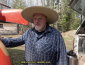 Tim standing by the canoe trailer