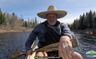 Tim seated in a canoe, cover photo for canoe poling video