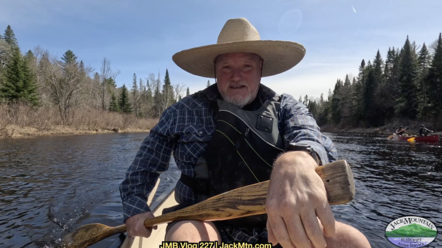 Tim seated in a canoe, cover photo for canoe poling video