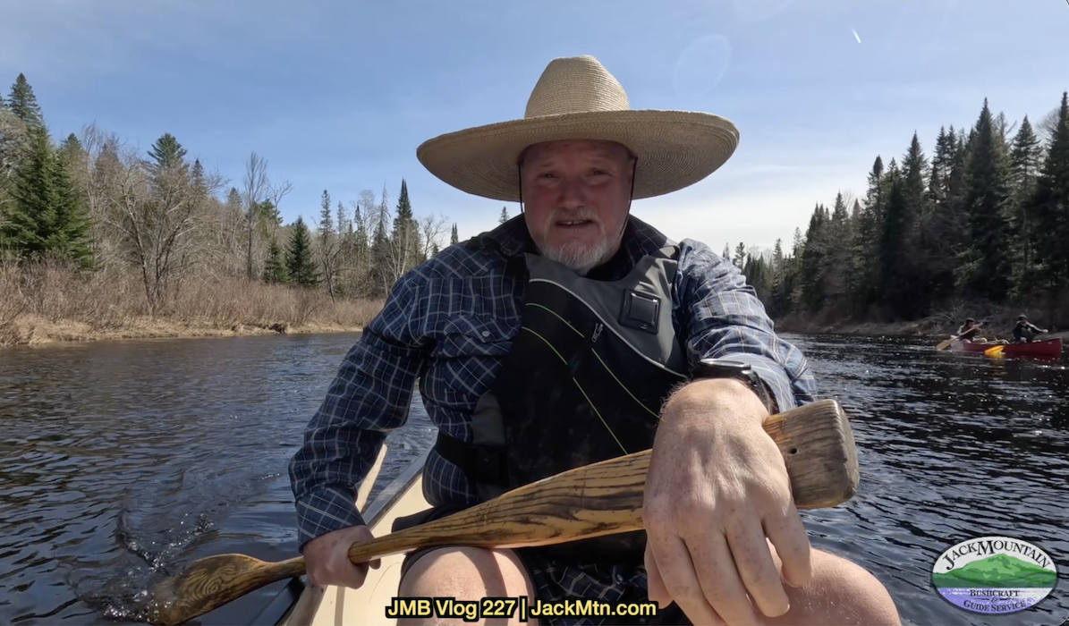 Tim seated in a canoe, cover photo for canoe poling video