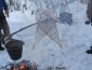 suspending a pot over a fire using snowshoes and a pole