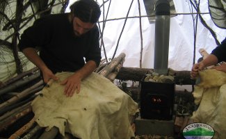 pulling a deer hide in a homemade sauna