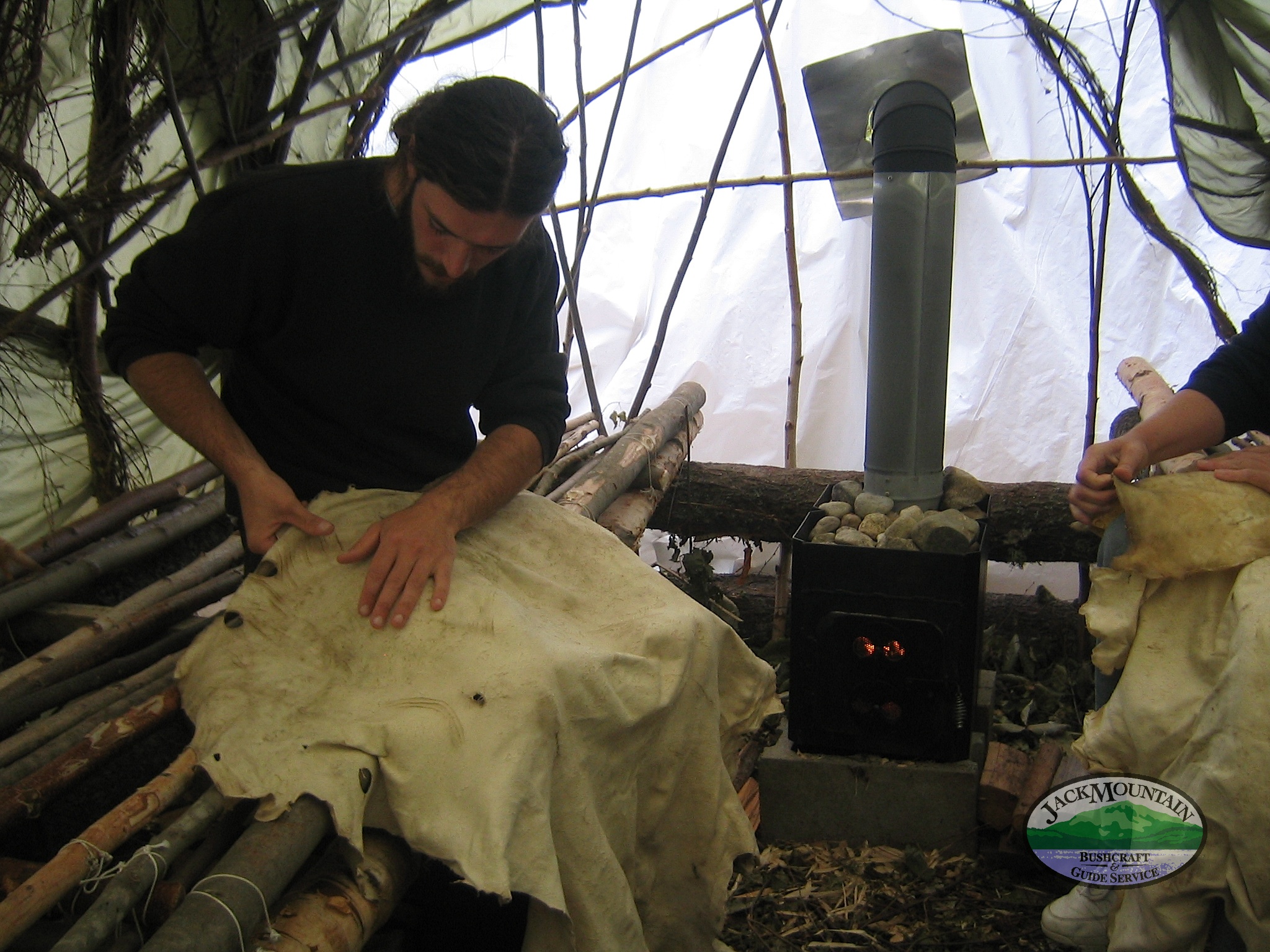 pulling a deer hide in a homemade sauna
